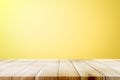 Empty wooden deck table over yellow wallpaper background. Royalty Free Stock Photo