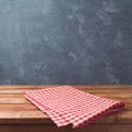 Empty wooden deck table with red cheched tablecloth over blackboard background for product montage display. Royalty Free Stock Photo