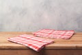 Empty wooden deck table with tablecloth over bright rustic background for product montage Royalty Free Stock Photo