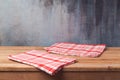 Empty wooden deck table with tablecloth over painted wall background Royalty Free Stock Photo