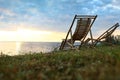 Empty wooden deckchairs on hill