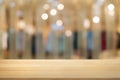 empty wooden desk over blurred coffee shop cafe background