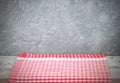 Empty wooden desk table and red checked tablecloth over mint wallpaper background Royalty Free Stock Photo