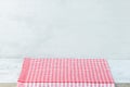 Empty wooden desk table and red checked tablecloth over mint wallpaper background Royalty Free Stock Photo