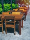 Wooden dining table set near the green garden Royalty Free Stock Photo