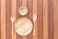 Empty wooden dish, fork, spoon and bowl on wooden table