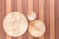 Empty wooden dish, fork, spoon and bowl on wooden table Royalty Free Stock Photo