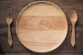 Empty wooden dish , fork and spoon on wooden background Royalty Free Stock Photo