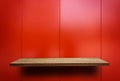 Empty wooden display shelf on Shiny red metal plate