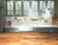 Empty wooden display table top front with blurred kitchen on background