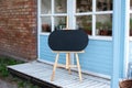 Empty Wooden easel on street. Signboard on street. Black board with wooden frame standing in garden. copy space. Plate for text. B