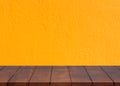 Empty wooden floor.Cement yellow wall background