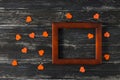 Empty wooden frame with hearts on a textured background. Orange hearts. Empty place