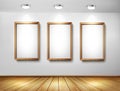 Empty wooden frames on wall with spotlights and wo