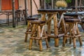 Empty wooden furniture set, table with crutches, rainy day in the caring industry, garden and terrace furniture Royalty Free Stock Photo