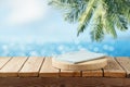 Empty wooden log with blue tablecloth on table over tropical beach bokeh background. Summer mock up for design and product Royalty Free Stock Photo