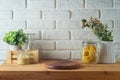 Empty wooden log on kitchen table over white brick wall background. Kitchen mock up for design and product display Royalty Free Stock Photo