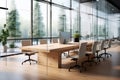 empty wooden meeting table on the background of a modern office with glass partitions