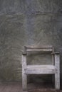 Empty, wooden old chair with old dirty cement color grey wall vintage background. Royalty Free Stock Photo