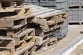 empty wooden pallets and new construction tiles