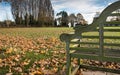 Empty wooden park bench seen in late autumn. Royalty Free Stock Photo