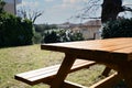 Empty wooden picnic table with bench in backyard on sunny day Royalty Free Stock Photo