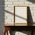 Empty wooden picture frame casting a shadow on a rustic wooden table against a brick wall isolated on white background Royalty Free Stock Photo