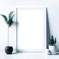 Empty wooden picture frame mockup. Golden vase with plant on white table. White wall background. Elegant working space. Royalty Free Stock Photo