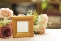 Empty wooden picture frame placed on a pink and white grid pattern background flower decoration Royalty Free Stock Photo