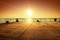 Empty wooden pier at beautiful colorful morning. Tourist wharf in sea bay.