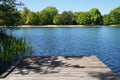 Empty wooden pier or jetty overlooking lake Royalty Free Stock Photo