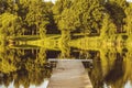 Empty wooden pier on a quiet lake in the morning Royalty Free Stock Photo