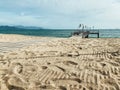 Empty wooden pier on the shore of a beautiful sandy beach Royalty Free Stock Photo