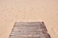 Empty wooden pier walkway on sea shore sandy tropical beach background Royalty Free Stock Photo