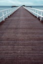 Empty wooden pier walkway on sea shore