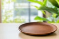 Empty wooden plate on table with blurred background of greenery creating serene atmosphere Ideal for showcasing food or Royalty Free Stock Photo