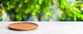 Empty wooden plate on white table over blur green trees nature with bokeh background, Blank wood dish for food display montage Royalty Free Stock Photo