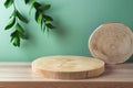 Empty wooden podium log for presentation on table over green background. Cosmetic mock up for design and product display