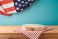 Empty wooden podium log with tablecloth on table over USA flag background. American national holiday mock up for design and Royalty Free Stock Photo