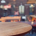 Empty wooden round table over outdoor restaurant background Royalty Free Stock Photo