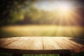 Empty wooden round table for product display with blurred garden background. Ai generative Royalty Free Stock Photo