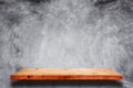 Empty wooden shelf with bare concrete background. Royalty Free Stock Photo