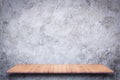 Empty wooden shelf with bare concrete background. Royalty Free Stock Photo