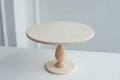 Empty wooden stand for cake on white background. Royalty Free Stock Photo