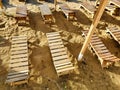 Empty wooden sun loungers on sea shore. Lifestyle