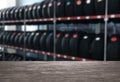 Empty wooden surface and view of car tires in auto store, closeup. Space for text