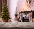 Empty wooden surface and blurred view of room decorated for Christmas, space for text. Interior design Royalty Free Stock Photo