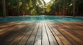 An empty wooden surface harmonizes with a tropical hotel swimming pool, creating a summer-inspired scene