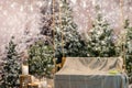 Empty wooden swing with a blanket in a snow-covered park or a forest while snowing, concept about Christmas and New Year holiday Royalty Free Stock Photo