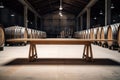 empty wooden table against the backdrop of a huge wine hangar Royalty Free Stock Photo